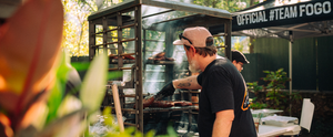 Interstellar BBQ's pitmaster expertly sears steaks over flames on a custom 3-foot live-fire table designed by Cen-Tex Smokers.